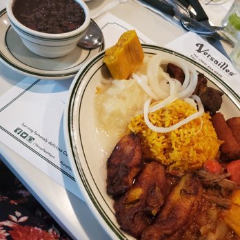 Versailles - Sampler: Beans, tamal type dish, plantains, rice, yuca en mojo, ropa vieja, croquetas - Cuban Near Me - Miami, Florida Versailles - Sampler: Beans, tamal type dish, plantains, rice, yuca en mojo, ropa vieja, croquetas - Cuban Near Me - Miami, Florida