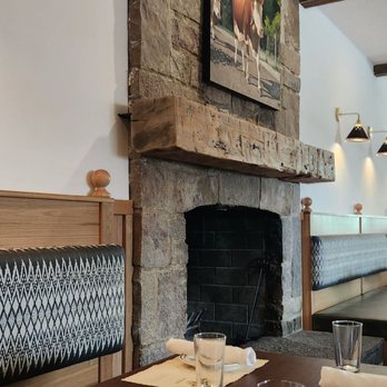 Alpino - a dining room with a fireplace in the background - German Near Me - Detroit, Michigan