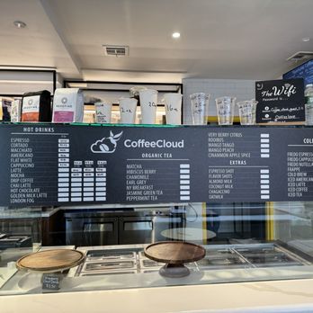Coffee Cloud - a coffee cloud menu displayed on a glass counter - Cafes Near Me - Briarwood, New York