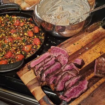 2dye4que - a cutting board with meat and vegetables on it - Barbeque Near Me