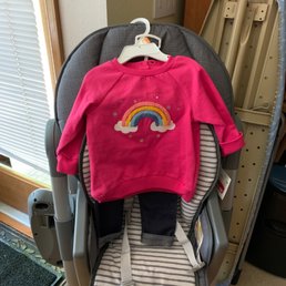A cute little outfit. Rainbow sweat shirt with jeans
