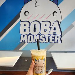 a hand holding a boba bubble tea