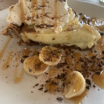 Cowfish - Homemade pecan crusted banana cream pie with freshly made whip cream and caramel drizzle. - New American Near Me - Hampton Bays, New York Cowfish - Homemade pecan crusted banana cream pie with freshly made whip cream and caramel drizzle. - New American Near Me - Hampton Bays, New York