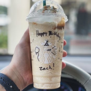 Starbucks - a hand holding a cup of iced coffee - Coffee & Tea Near Me - Sevierville, Tennessee Starbucks - a hand holding a cup of iced coffee - Coffee & Tea Near Me - Sevierville, Tennessee