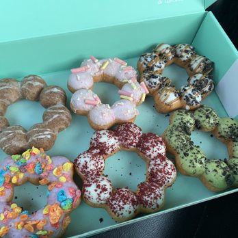 Dochi - Top left is Ube Glazed-purple in the middle. - Donuts Near Me - Seattle, Washington Dochi - Top left is Ube Glazed-purple in the middle. - Donuts Near Me - Seattle, Washington