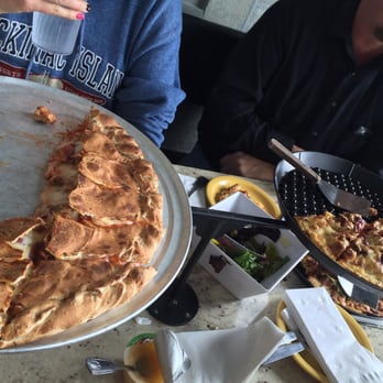 Silver Beach Pizza - Left is large pepperoni, sausage and bacon calzone. Right is pepperoni, sausage, bacon, garlic specialty pizza. - Pizza Near Me - Saint Joseph, Michigan Silver Beach Pizza - Left is large pepperoni, sausage and bacon calzone. Right is pepperoni, sausage, bacon, garlic specialty pizza. - Pizza Near Me - Saint Joseph, Michigan