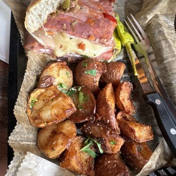 Succotash Southern and Creole Kitchen - Muffalata with fried potatoes - Southern Near Me - Durham, North Carolina Succotash Southern and Creole Kitchen - Muffalata with fried potatoes - Southern Near Me - Durham, North Carolina