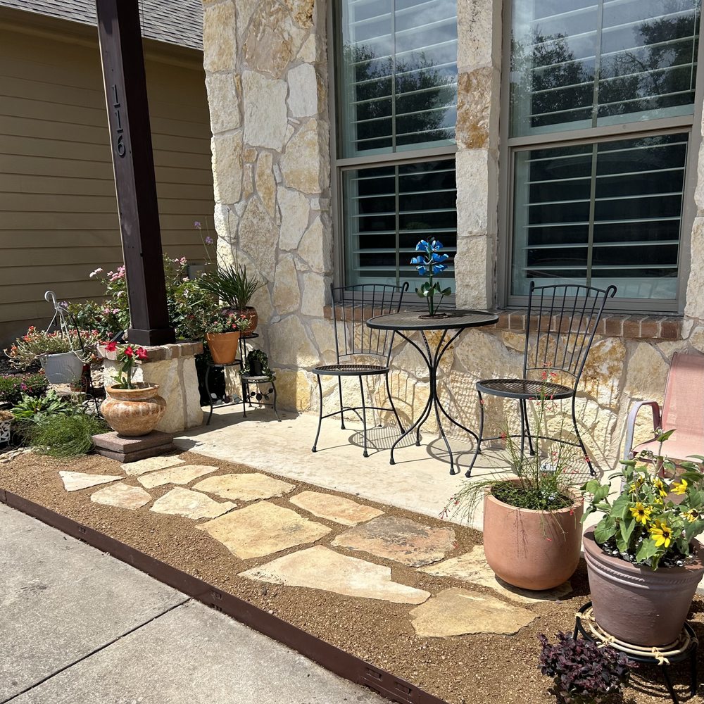 a patio with a table and chairs