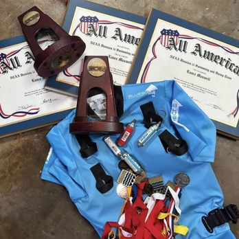 Surf Lessons Ocean Beach - Instructor Lance is a former Lifeguard and 5xAll-American swimmer. These are some of his awards next to his inflation big wave safety vest. - Surf Schools Near Me - San Francisco, California Surf Lessons Ocean Beach - Instructor Lance is a former Lifeguard and 5xAll-American swimmer. These are some of his awards next to his inflation big wave safety vest. - Surf Schools Near Me - San Francisco, California