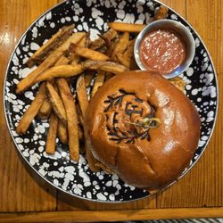 Farmhouse burger and fries. The bun is branded, cool touch.