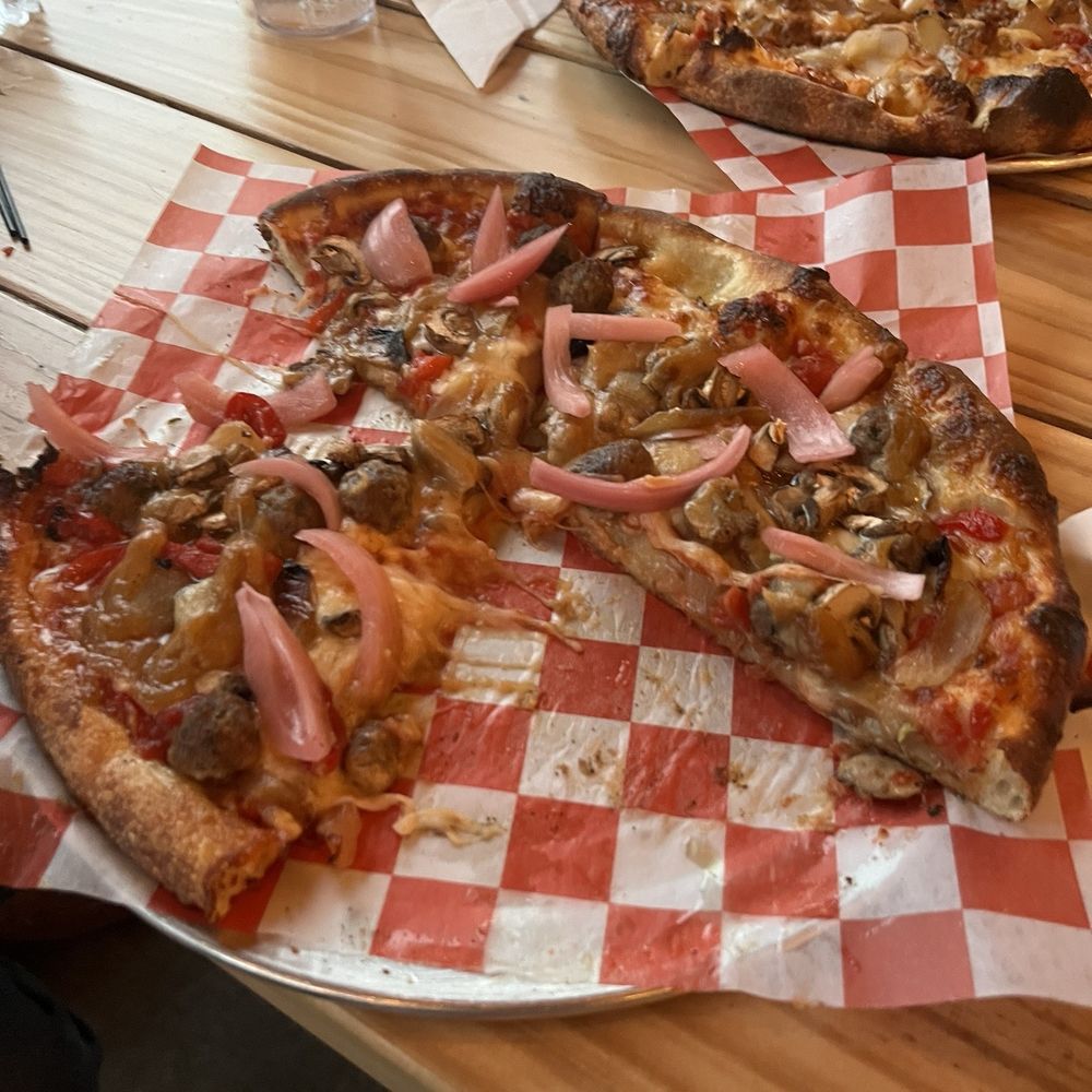 Nocturnal pizza and too pizza is red sauce base with sausage and charred onion. Nocturnal pizza and too pizza is red sauce base with sausage and charred onion.
