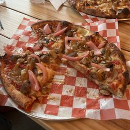Nocturnal pizza and too pizza is red sauce base with sausage and charred onion. Nocturnal pizza and too pizza is red sauce base with sausage and charred onion.