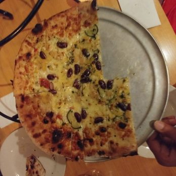 American Flatbread - A half eaten small pizza - Pizza Near Me - Burlington, Vermont