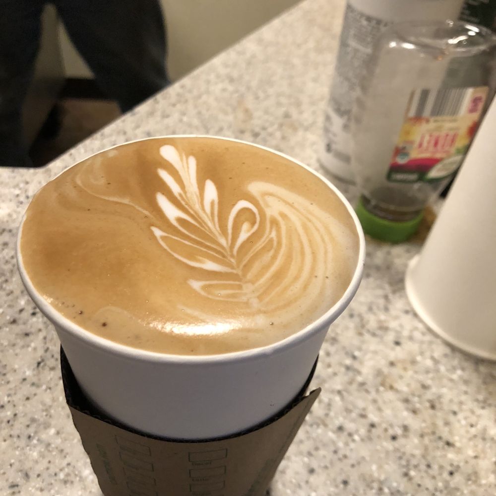 a cup of coffee on a counter a cup of coffee on a counter