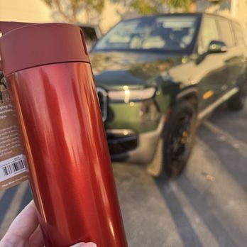 Rivian Service Center - Red Canyon Water Bottle in front of a Forest Green R1S. (I wasn't sure on color) - Auto Repair Near Me - Lake Forest, California Rivian Service Center - Red Canyon Water Bottle in front of a Forest Green R1S. (I wasn't sure on color) - Auto Repair Near Me - Lake Forest, California