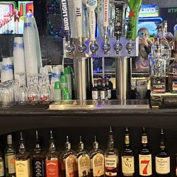 Gilmore’s Sports Bar - Beer on tap and other liquor on bottom.