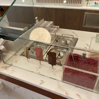 Neuhaus - a counter with a variety of desserts - Chocolatiers & Shops Near Me
