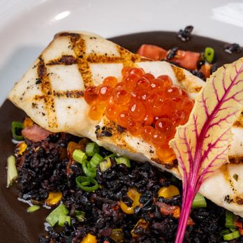 Everglades Restaurant - Char-Grilled Halibut with fire-roasted corn, tomato, green onion, black garlic sauce, and salmon caviar - Seafood Near Me - Orlando, Florida Everglades Restaurant - Char-Grilled Halibut with fire-roasted corn, tomato, green onion, black garlic sauce, and salmon caviar - Seafood Near Me - Orlando, Florida