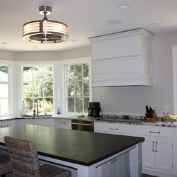 This retro ceiling fan looks sleek in this Highlands kitchen. A unique fan is a great alternative to pendants over an island!