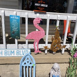 Compulsive Cravings Antiques - Blue wood arch, mermaid figurine holding bowl, metal flamingo, beach bum sign, metal mermaid, & crab sign