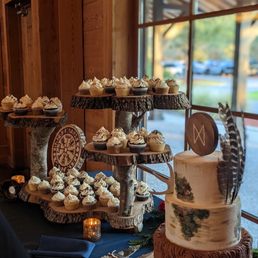 Wood cake stand with various flavored cupcakes and a large red velvet cake! Cake and cake stand totally went with our themed wedding.