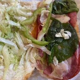 a sub sandwich with lettuce and meat a sub sandwich with lettuce and meat