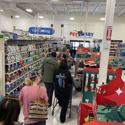 Long line of people waiting to be checked out with only one cashier on the register at 12 o'clock on a Saturday