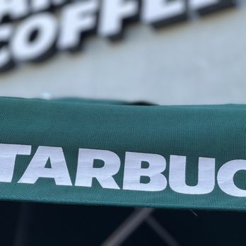Starbucks - Outside umbrella used for waiting area during this rainy seating. - Coffee & Tea Near Me - San Jose, California