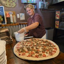 Benny Adelinas - One of the employees making a pizza.