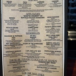 Menu - A menu board from The Tap features sections for salads, appetizers, hand-helds, and sides, with prices and descriptions for each item.