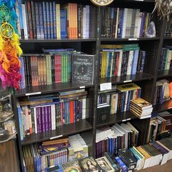 Curious Goods New Age Shop - Books on spirituality, tarot cards, and the super natural are stacked from the floor to ceiling.