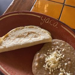 Yaca - Quesadillas and Beans with cheese on a platter.