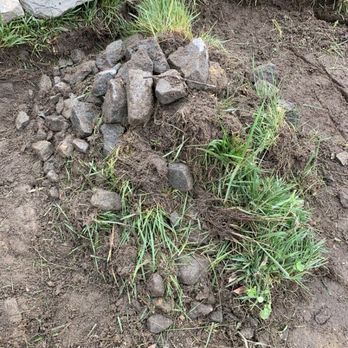 Fancy Cutz - a pile of rocks and grass - Landscaping Near Me - Bridgeville, Delaware