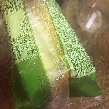 7-Eleven - a person holding a sandwich wrapped in plastic - Convenience Stores Near Me - South San Francisco, California