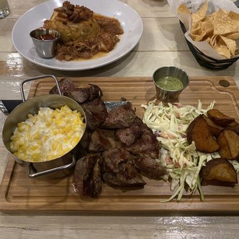 Sofrito Restaurant & Bar - Carne asado on wooden platter; mofongo on white plate - Latin American Near Me - Greenville, South Carolina Sofrito Restaurant & Bar - Carne asado on wooden platter; mofongo on white plate - Latin American Near Me - Greenville, South Carolina