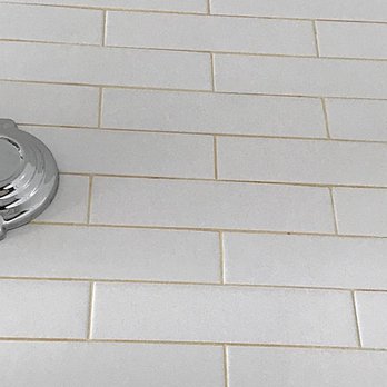 Malek Managmnt - Yellowed grout from leak between walls. - Property Management Near Me - Brooklyn, New York