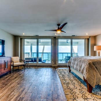 Greg Putman Construction - a bedroom with a large bed and a flat screen tv - General Contractors Near Me Greg Putman Construction - a bedroom with a large bed and a flat screen tv - General Contractors Near Me