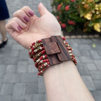 Meaney's Mini Donuts - a woman's hand holding a wooden bracelet - Donuts Near Me - Sarasota, Florida