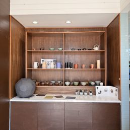 Another wall with handmade pottery, right next to the counter and the restrooms
