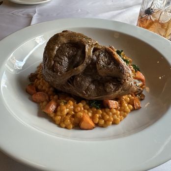 Hoq Restaurant - Braised lamb shank with cous cous and seasonal vegetables. - New American Near Me - Des Moines, Iowa