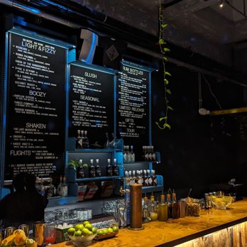 Cotton & Reed - a bar with a menu on the wall - Distilleries Near Me - Washington, DC, District of Columbia