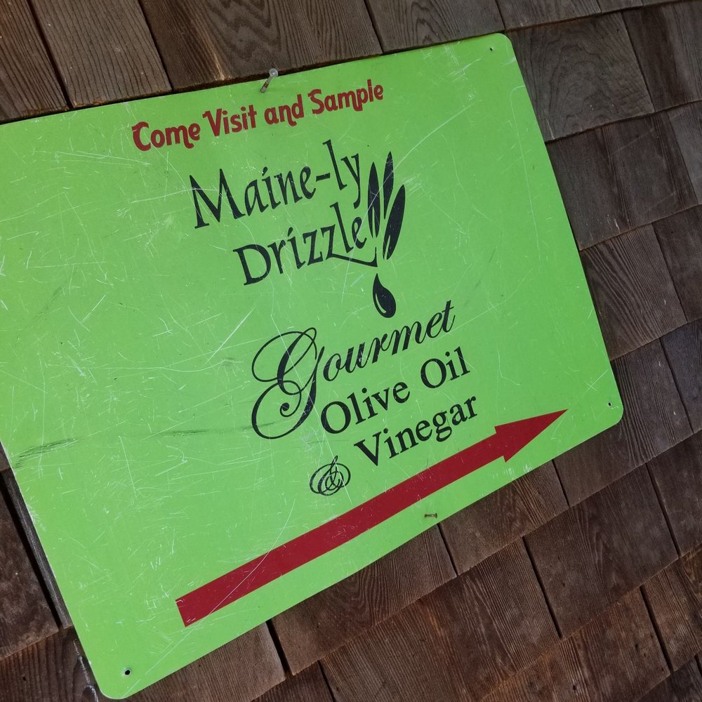 Maine-ly Drizzle - a sign on the side of a building - Olive Oil Near Me - Ogunquit, Maine