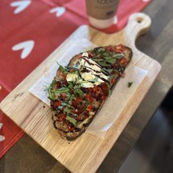 Ground & Toasted - Sourdough toast with burrata, arugula, tomatoes, balsamic glaze drizzle and a touch of maldon salt.