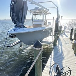 Sarasota Boat Detailing - 25 Sportsman On Lift with catwalk on far side.