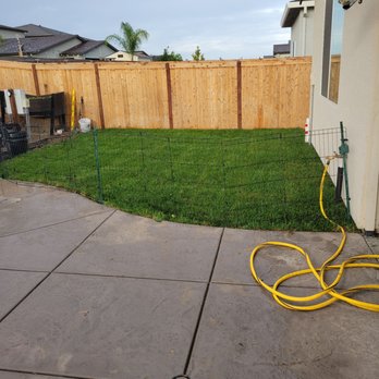 Flores Landscaping And Design - a backyard with a fence and a hose - Masonry/Concrete Near Me Flores Landscaping And Design - a backyard with a fence and a hose - Masonry/Concrete Near Me