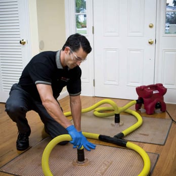 City Water Damage - a man using a hose to clean the floor - Home Cleaning Near Me - Los Angeles, California City Water Damage - a man using a hose to clean the floor - Home Cleaning Near Me - Los Angeles, California