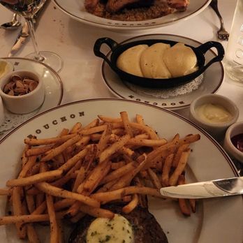 Bouchon - Back: Duck Confit Middle: truffle mashed potatoes (Puree de Pommes Au Truffe) Front: steak & frites (upgraded truffle fries) - French Near Me - Yountville, California Bouchon - Back: Duck Confit Middle: truffle mashed potatoes (Puree de Pommes Au Truffe) Front: steak & frites (upgraded truffle fries) - French Near Me - Yountville, California
