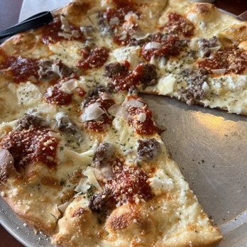 Leonardo’s Pizzeria - a pizza with a slice taken out of it - Pizza Near Me - Palm Harbor, Florida Leonardo’s Pizzeria - a pizza with a slice taken out of it - Pizza Near Me - Palm Harbor, Florida