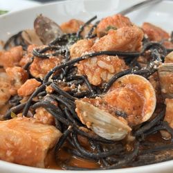 Flat Iron Grill - Seafood pasta in tomato sauce over squid ink pasta