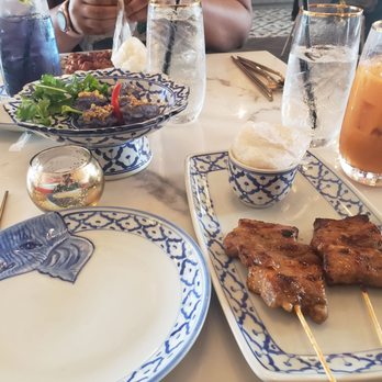 Kin Dee - Upper left: Butterfly pea drink, Middle: Flower Dumplings, Bottom right: Grilled pork belly with rice. - Thai Near Me - Houston, Texas Kin Dee - Upper left: Butterfly pea drink, Middle: Flower Dumplings, Bottom right: Grilled pork belly with rice. - Thai Near Me - Houston, Texas